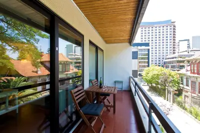 a balcony with a wooden table and chairs on it at VIVA Belos Ares in Porto