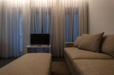 a living room with a couch and a tv at Domum in Porto