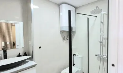 a bathroom with a shower and a toilet and a sink at Alma de Cedofeita Apartment in Porto