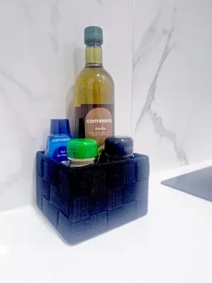 a bottle of alcohol and two batteries on a blue holder at Alma de Cedofeita Apartment in Porto