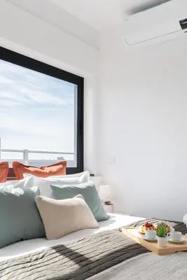 a white bedroom with a bed with a large window at Host Wise - Sunny Bright Flat w Balcony in Porto