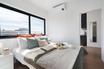 a bedroom with a large bed with a tray on it at Host Wise - Sunny Bright Flat w Balcony in Porto