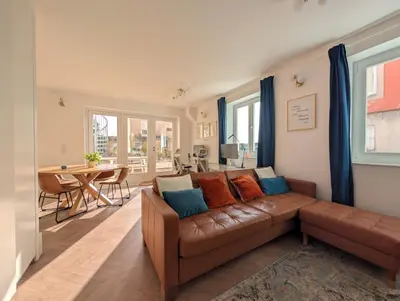 a living room with a brown couch and a table at dvnest - Premium 1BR Apartment Designed for Remote Work in Porto