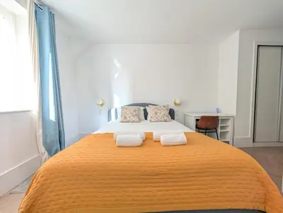 a bedroom with a large bed with two towels at dvnest - Premium 1BR Apartment Designed for Remote Work in Porto