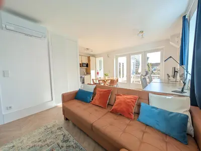 a living room with a brown couch with colorful pillows at dvnest - Premium 1BR Apartment Designed for Remote Work in Porto
