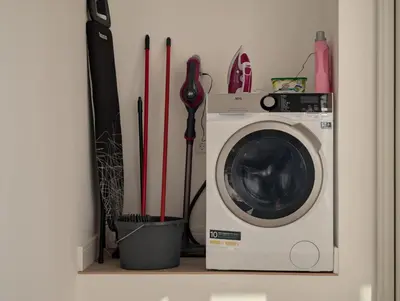 a washing machine sitting on a shelf with baseball bats at dvnest - Premium 1BR Apartment Designed for Remote Work in Porto
