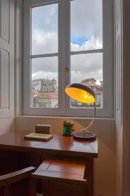 a lamp sitting on a desk in front of a window at Porto A.S. 1829 Hotel in Porto