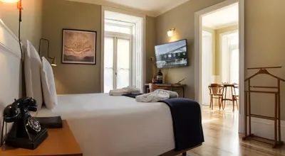 a bedroom with a large white bed in a room at Porto A.S. 1829 Hotel in Porto