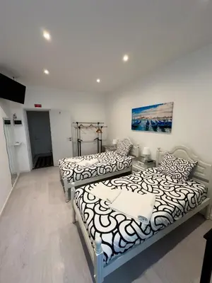 a room with two beds and a couch at Antero de Quental Studios 2 in Porto