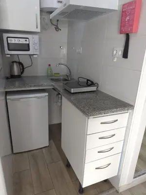 a small kitchen with a counter and a sink at Antero de Quental Studios 2 in Porto