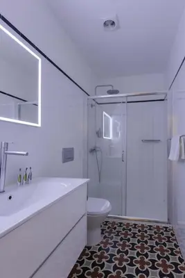 a bathroom with a tub and a toilet and a shower at Liiiving in Porto - Trindade Deluxe Studios in Porto
