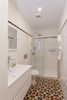 a bathroom with a shower and a sink and a toilet at Liiiving in Porto - Trindade Deluxe Studios in Porto