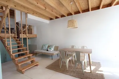 a dining room with a table and a staircase at Wood & Blue House - Porto in Porto