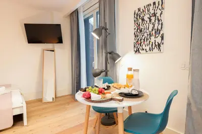 a table with a plate of food on it in a room at Urban Stylish Studio with Balcony in Porto