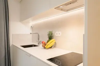 a kitchen with a sink and a fruit basket on the counter at Urban Stylish Studio with Balcony in Porto