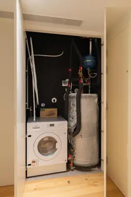 a laundry room with a washing machine and christmas decorations at Urban Stylish Studio with Balcony in Porto