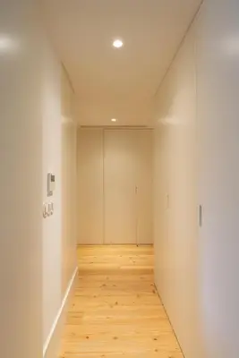 an empty hallway with white walls and wood floors at Urban Stylish Studio with Balcony in Porto