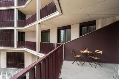 a balcony of a building with a table and chairs at Urban Stylish Studio with Balcony in Porto