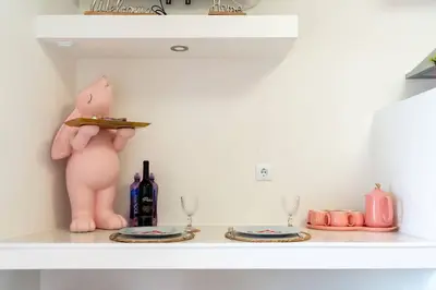 a shelf with two plates and a pig with a knife at The Charm Bonfim OPO in Porto