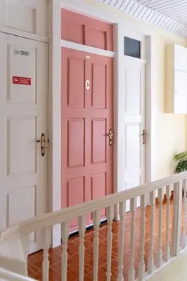 a staircase with a red door and two white doors at The Charm Bonfim OPO in Porto