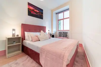 a bedroom with a large bed and a window at The Charm Bonfim OPO in Porto