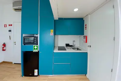 a blue kitchen with a sink and a refrigerator at Bonsai Apartment 6 in Porto