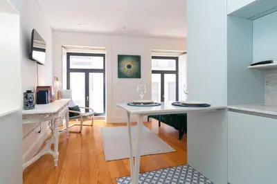 a kitchen with a table with two glasses on it at Formosa Studios by Upperground in Porto