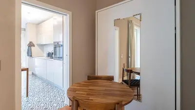 a dining room with a table and a mirror at Cardosas Spacious Studio by LovelyStay in Porto
