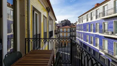 a balcony with a table and chairs on a city street at Cardosas Spacious Studio by LovelyStay in Porto