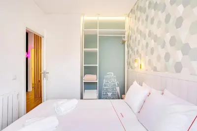 a bedroom with a white bed with two white pillows at Oporto Vibes - T1 Moderno no Centro do Porto com AC, by HopStays in Porto