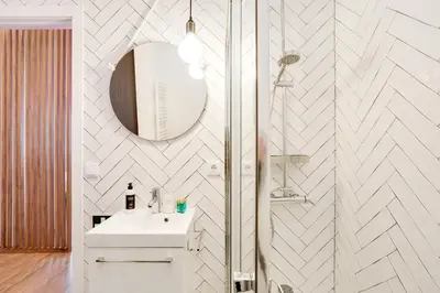 a white bathroom with a sink and a mirror at Oporto Vibes - T1 Moderno no Centro do Porto com AC, by HopStays in Porto