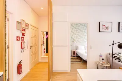 a living room with a mirror and a room with a couch at Oporto Vibes - T1 Moderno no Centro do Porto com AC, by HopStays in Porto