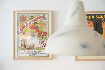 a light fixture in front of a poster on a wall at GuestReady - Oporto Vintage in Porto