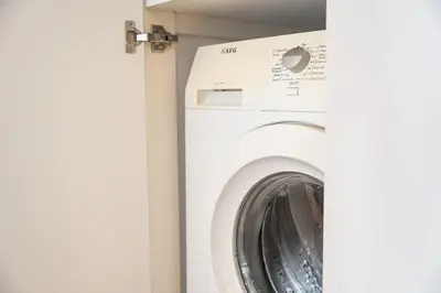 a white washer and dryer in a room at GuestReady - Oporto Vintage in Porto