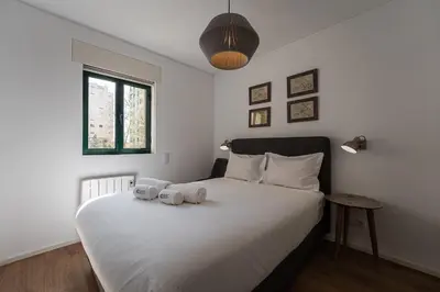 a bedroom with a bed with two towels on it at GuestReady - Oporto Vintage in Porto