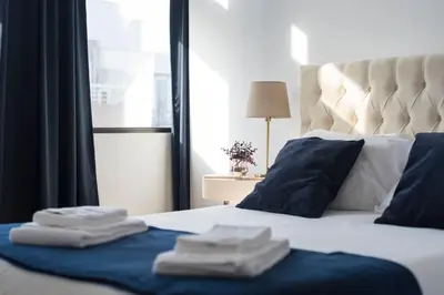 a bedroom with a bed with towels on it at O Herculano Porto in Porto