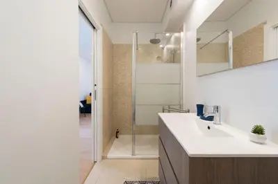 a bathroom with a sink and a shower at O Herculano Porto in Porto