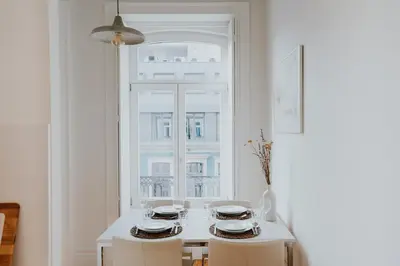 a white table with two chairs and a window at VIVA Contemporary Duque Terceira in Porto
