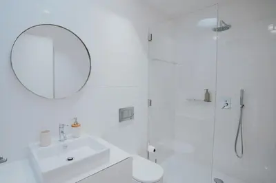 a white bathroom with a sink and a shower at VIVA Contemporary Duque Terceira in Porto