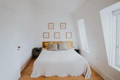 a white bedroom with a bed with white sheets at VIVA Contemporary Duque Terceira in Porto