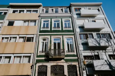 a tall building with a balcony in front of it at VIVA Contemporary Duque Terceira in Porto