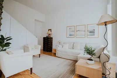 a living room with two white couches and a lamp at VIVA Contemporary Duque Terceira in Porto