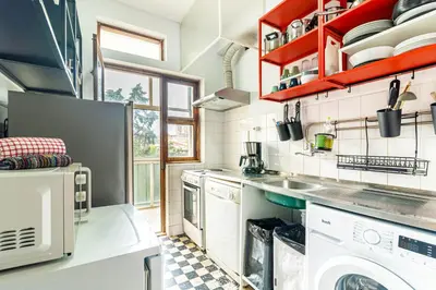 a living room with a white couch and chairs at Bonfim Sunny Vintage apartment in Porto