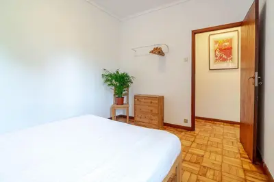 a kitchen with a sink and a red cabinet with utensils at Bonfim Sunny Vintage apartment in Porto