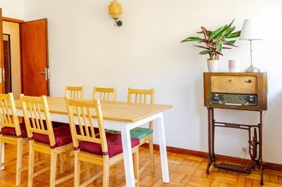 a living room with a table and a couch at Bonfim Sunny Vintage apartment in Porto