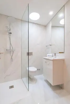 a bathroom with a shower and a toilet and a sink at Host Wise - Bright and Cozy House with Dom Luís Bridge View in Porto