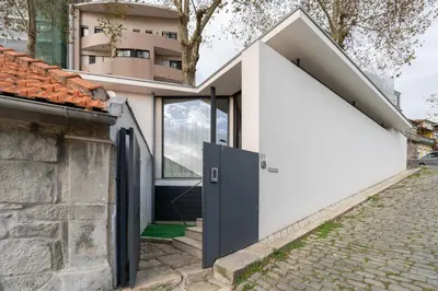 a house with a pivoting door on a street at Host Wise - Bright and Cozy House with Dom Luís Bridge View in Porto