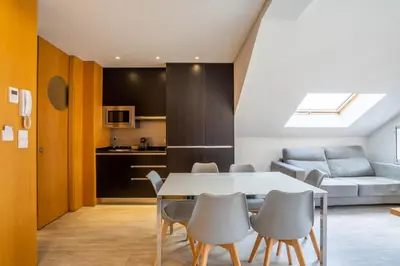 a kitchen and living room with a table and chairs at Smartr Porto Reis de Gaia & Spa in Vila Nova de Gaia