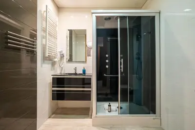 a bathroom with a glass shower and a sink at Smartr Porto Reis de Gaia & Spa in Vila Nova de Gaia