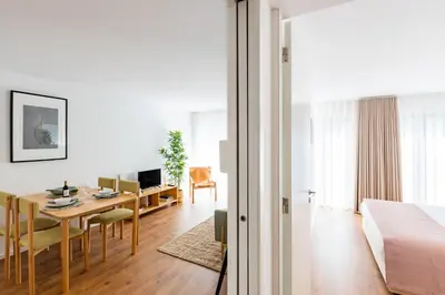 a bedroom and living room with a table and a bed at Porto Cozy and Design Apartment in Porto Center in Porto